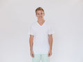Model wearing a plain white V-neck cotton t-shirt against a light background
